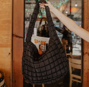 Enhance any look effortlessly with this ultra-stylish puckered fabric carryall shoulder strap bag, designed to add just the right amount of texture and depth. Crafted in a relaxed, slouchy silhouette and adorned with a puckered finish, it boasts a drawstring adjustable shoulder strap for versatile wear.